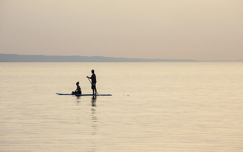 People padding paddle booat